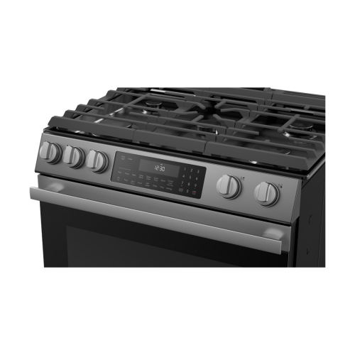 Stainless steel gas slide-in range with digital control panel and cast iron grates in modern kitchen appliances collection