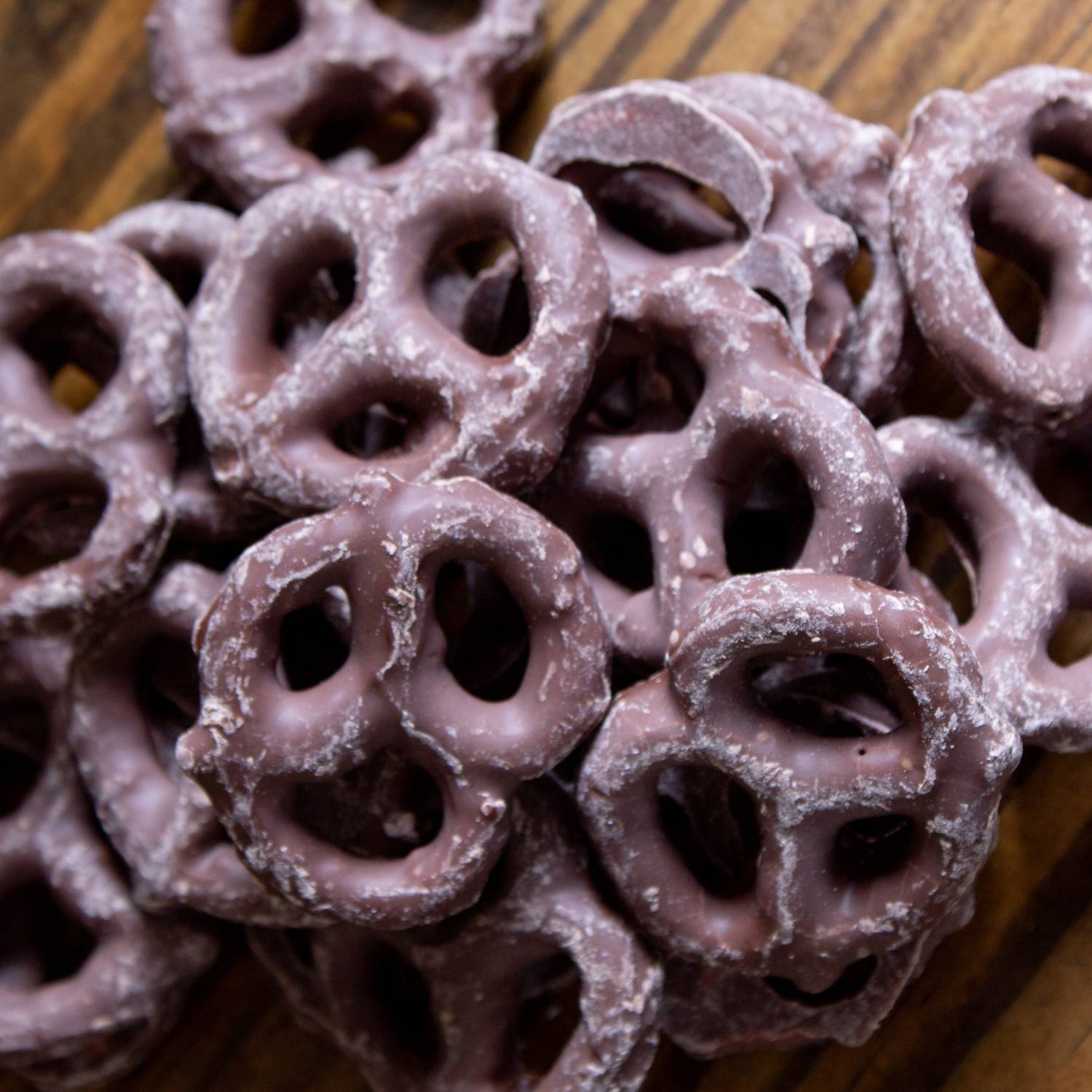 Close-up of mini pretzels coated in smooth chocolate, part of Chips & Snacks and Food & Beverage selections under $50
