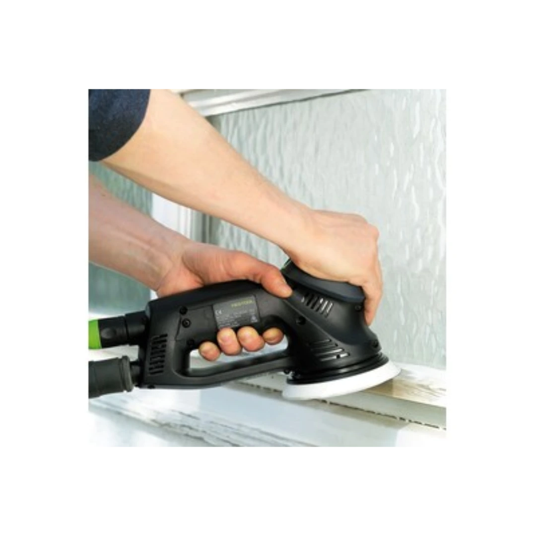 Person using a black rotary sander with a soft white pad on a wooden surface for woodworking tool accessory use
