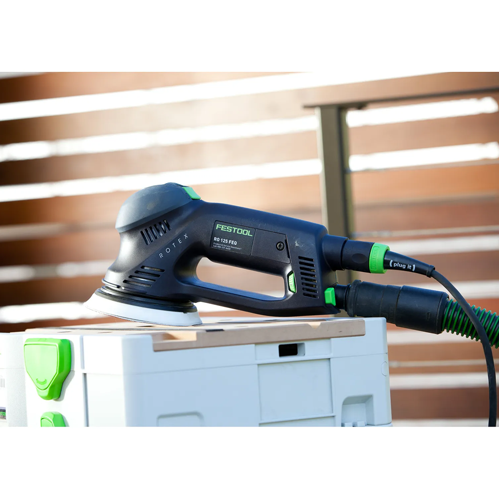 Festool 576032 dual mode sander resting on white storage box for power tools in home improvement setting