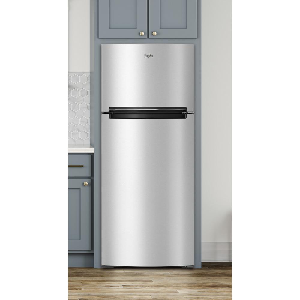 Stainless steel top-freezer refrigerator fitted in kitchen cabinetry with gray cabinets and wood flooring