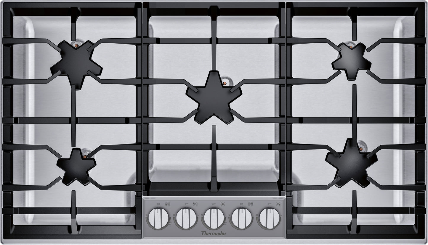 Top view of stainless steel 36-inch gas cooktop with five burners and front control knobs from Thermador Appliances collection
