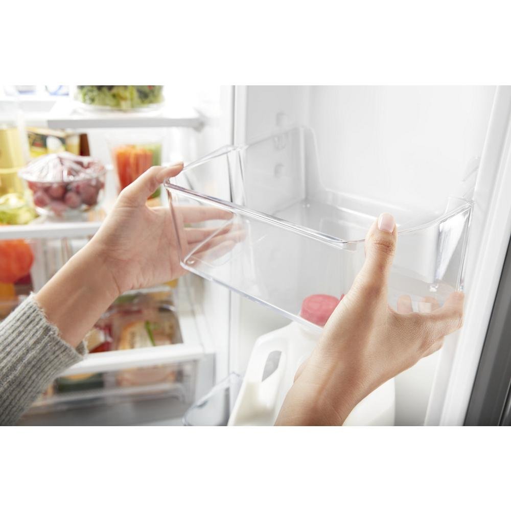 Hands removing clear storage bin from inside white refrigerator door in kitchen appliances collection