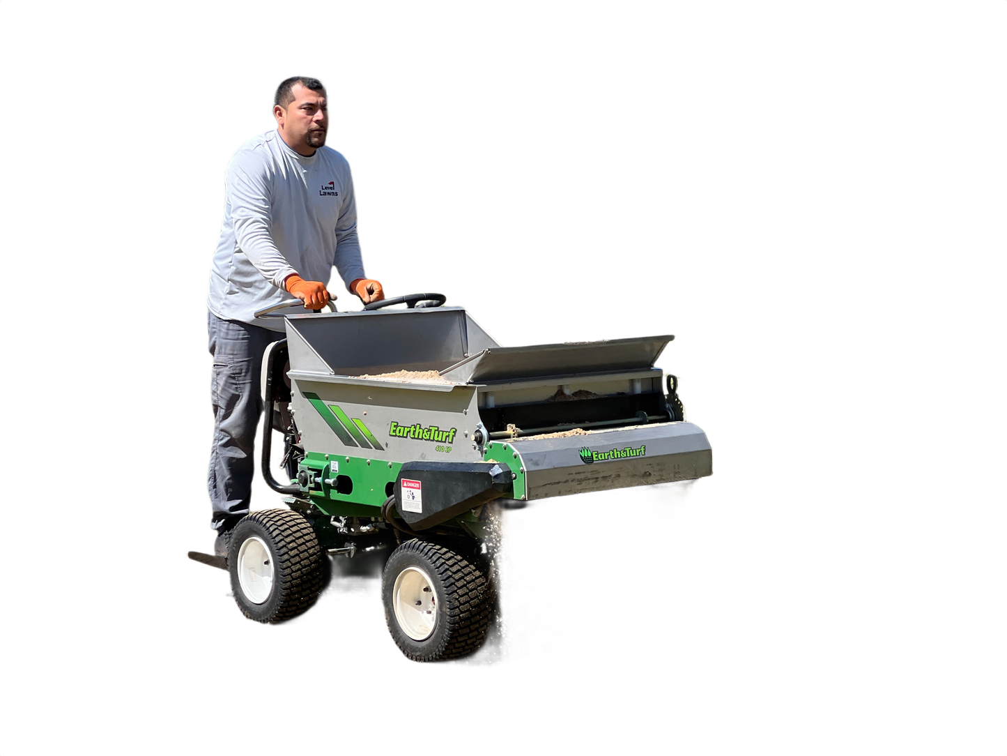 Man operating green and gray stand-on top dresser spreading soil for landscaping in All Products collection