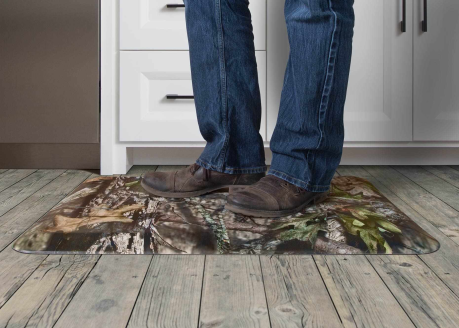 Comfort mat with outdoors-inspired camo pattern providing foot and back relief in kitchen and bathroom settings