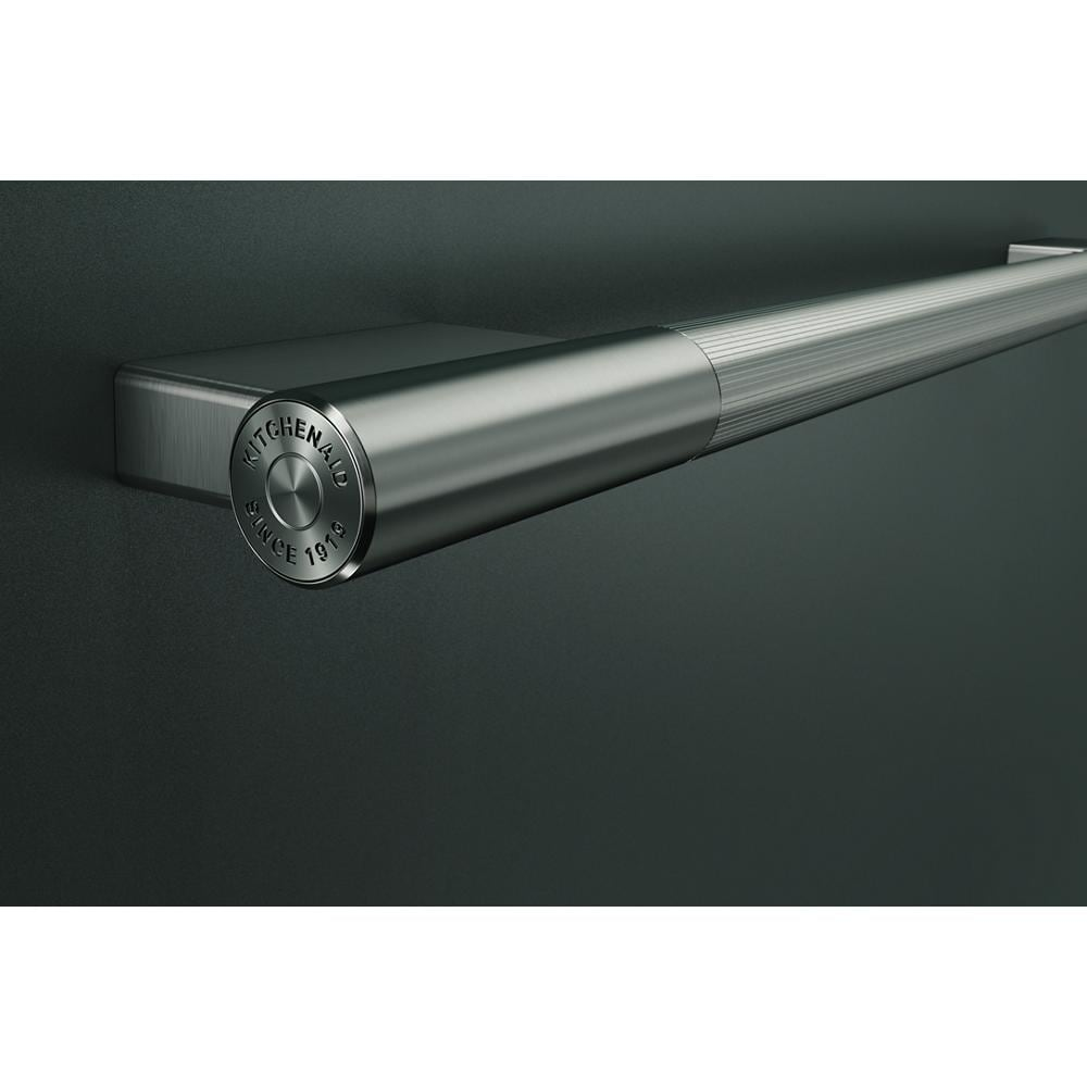 Brushed stainless steel cylindrical towel bar handle with subtle engraved logo on dark matte dishwasher surface
