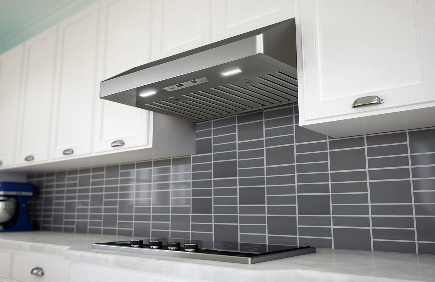 Modern stainless steel under cabinet range hood with LED lights and baffle filters in kitchen and appliances setting