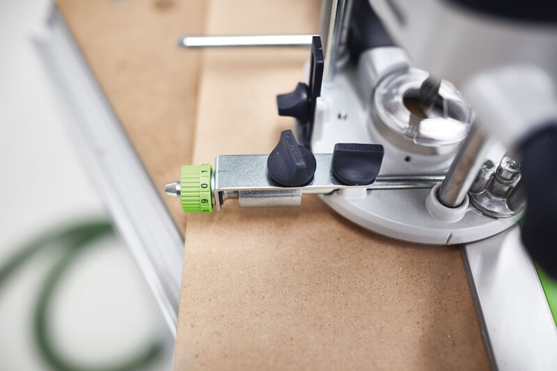 Fine adjustment stop with green numbered dial and black knobs on a wood router for precise tool settings in home improvement