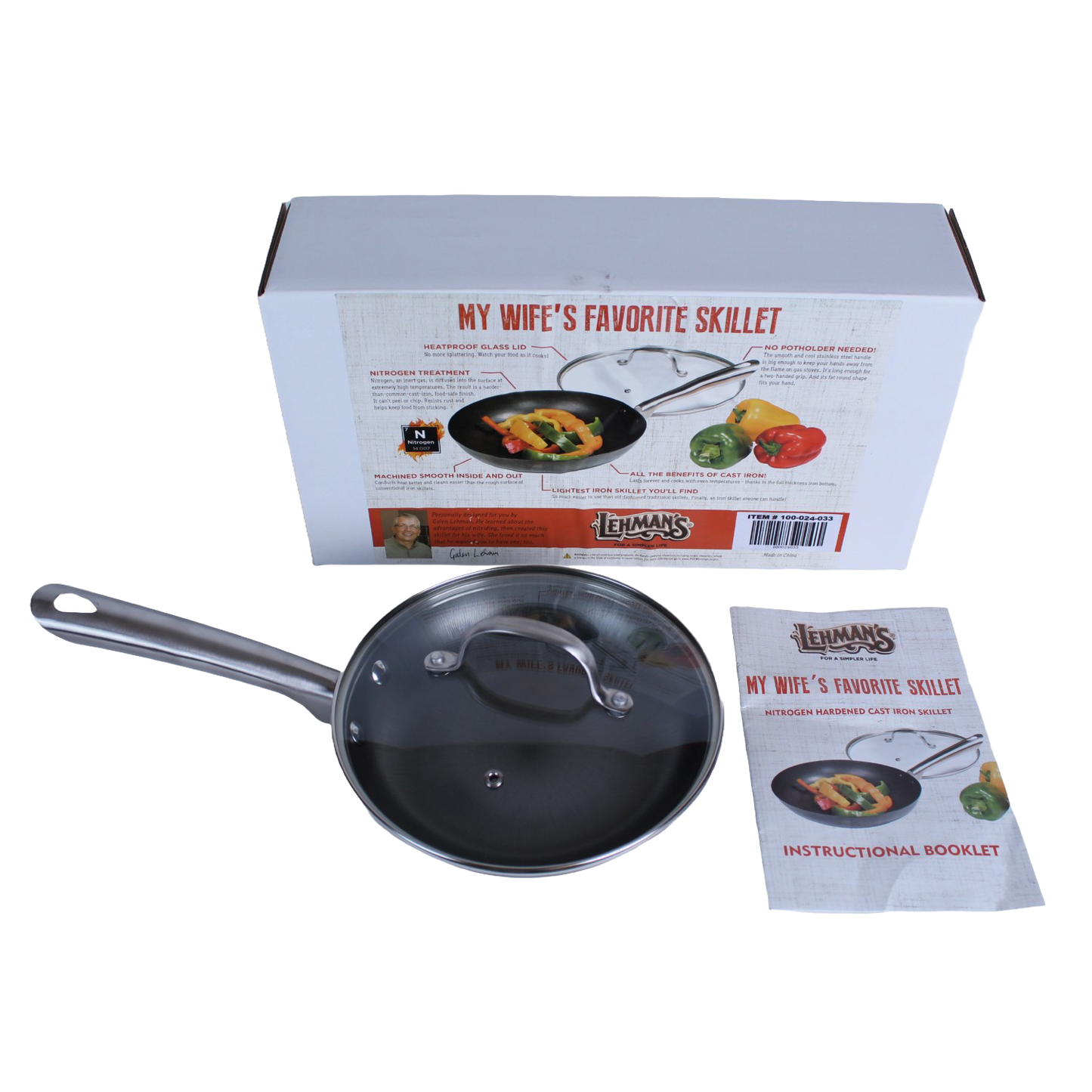 Nitrogen hardened cast iron skillet with glass lid and stainless steel handle beside packaging and instructional booklet in kitchenware collections
