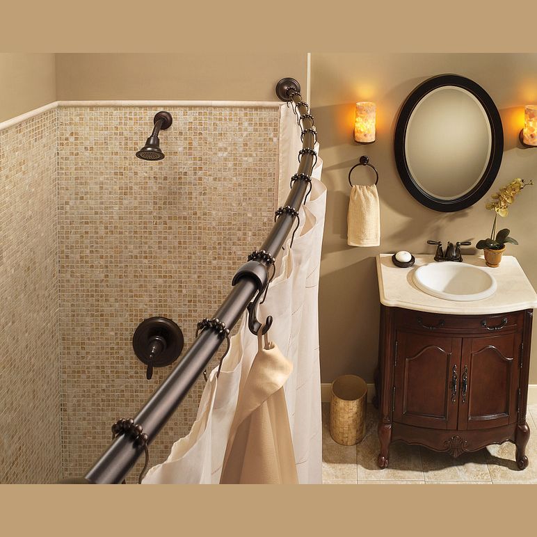 Old World Bronze shower curtain rings on curved rod in bathroom with mosaic tile shower and vintage vanity design
