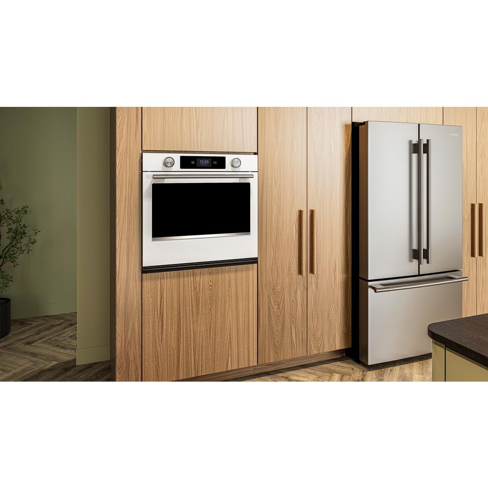 Built-in white smart electric wall oven with digital display and brushed wood cabinetry in modern kitchen setting