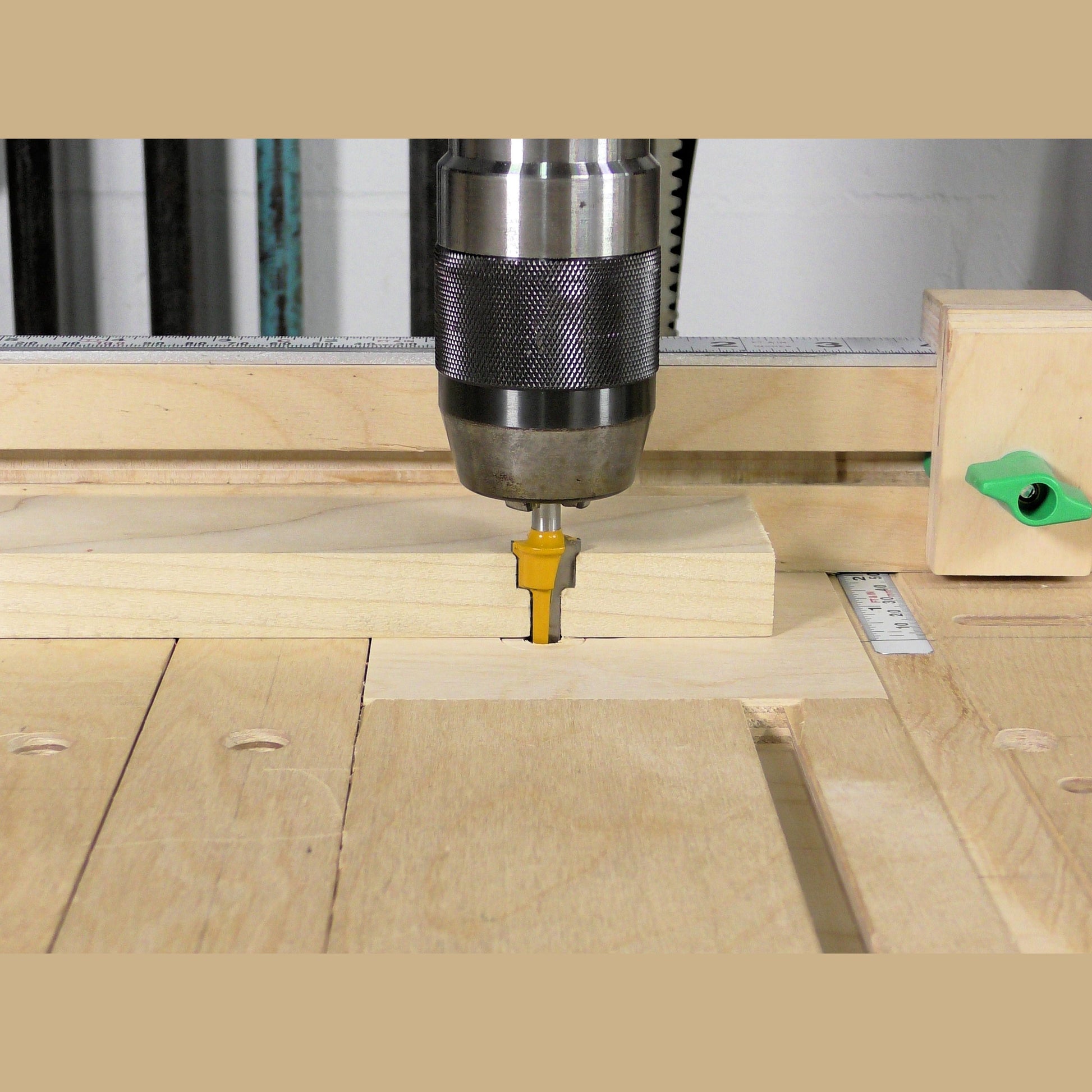 Yellow-tipped 2-step plunge router bit with 1/4-inch shank in a woodworking setup for power tool accessories collections
