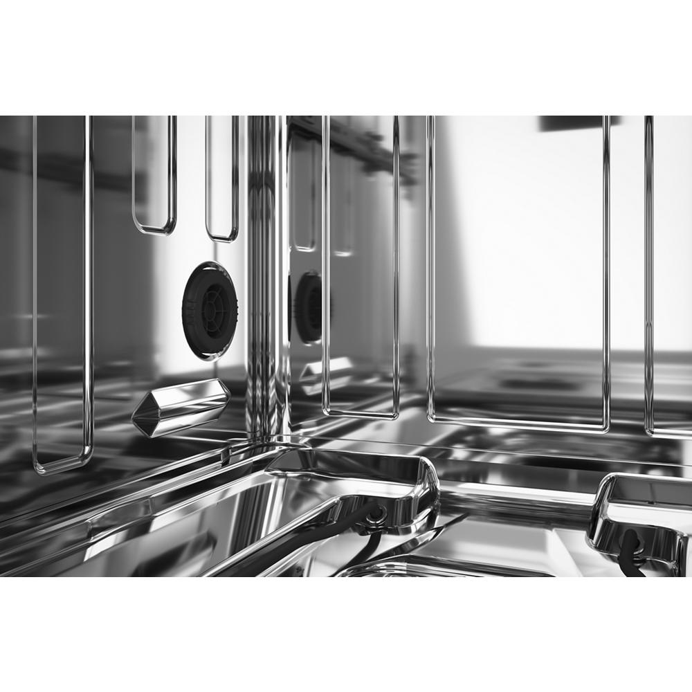 Close-up of stainless steel interior with wash jets and racks inside KitchenAid dishwasher from Appliances collection
