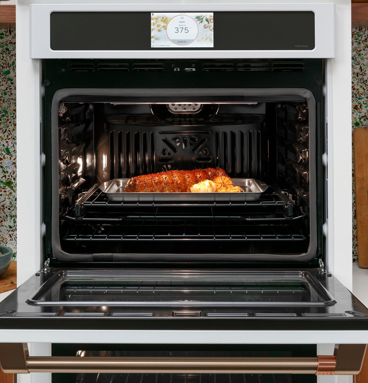 Open smart convection wall oven with a roast cooking inside on a metal tray, part of kitchen and appliances collection