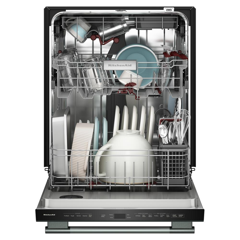 Open dishwasher loaded with clean white and clear dishes, bowls, utensils, and glassware in a stainless interior.