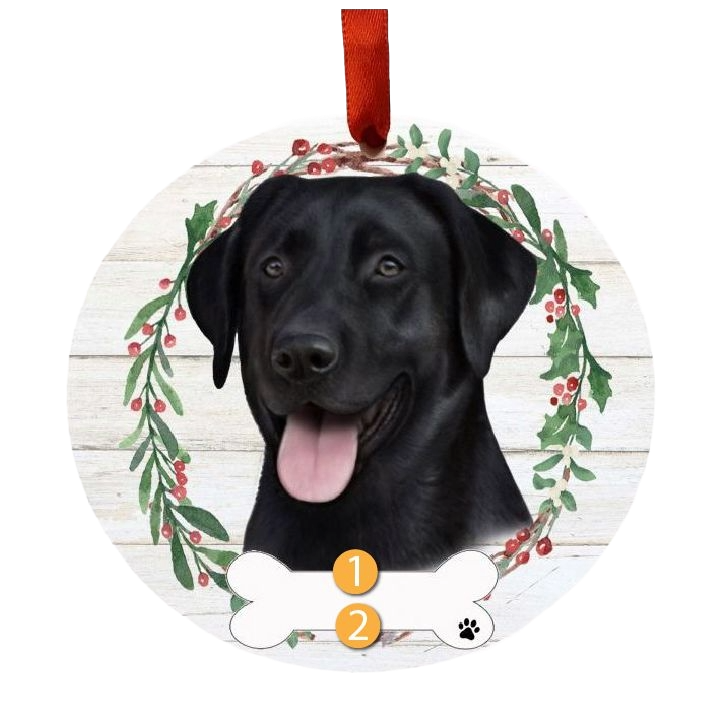 Round Christmas ornament with Black Labrador face inside a berry and greenery wreath and red ribbon hanger