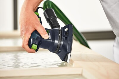 Festool sanding tool with green dust extraction hose used for precise woodworking in tool accessories collections