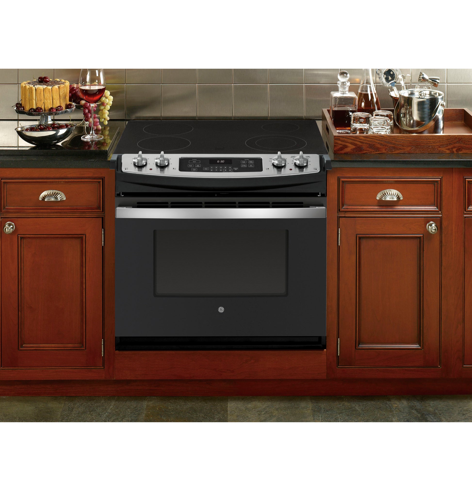 Black and stainless steel drop-in electric range with digital control and smooth glass cooktop in kitchen appliances collection