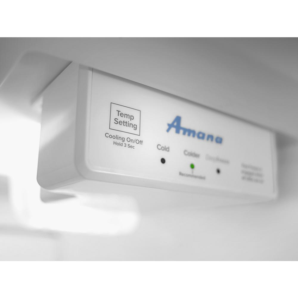 Close-up of white freezer control panel with temperature settings and indicator lights in kitchen appliances collection