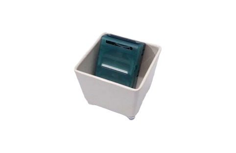 Small natural-finish organizing tray holding a compact dark green plastic item for home improvement use