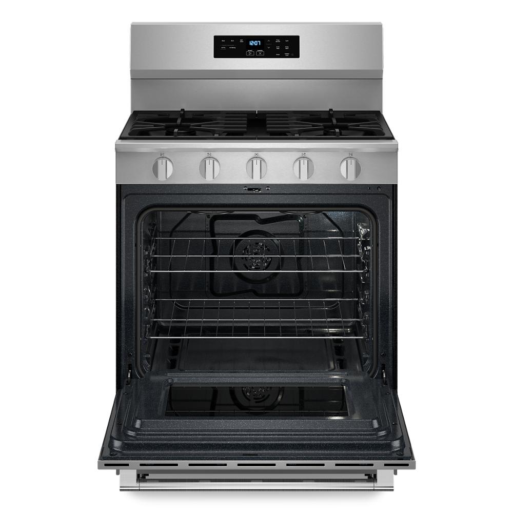 Stainless steel 30-inch gas range with open oven door, five control knobs, and digital display for kitchen appliances