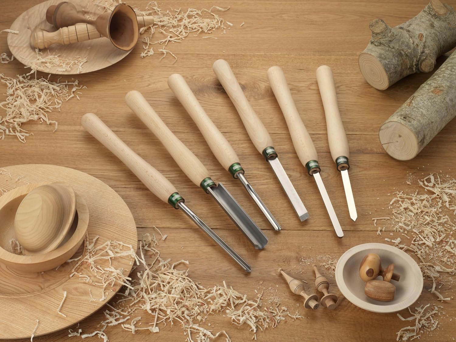 Six-piece woodturning tool set with 12-inch beech handles displayed with wood shavings and turned wooden objects for woodworking projects