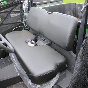 Black bench seat with contoured cushions inside a mid-size crossover utility vehicle for outdoor utility tasks