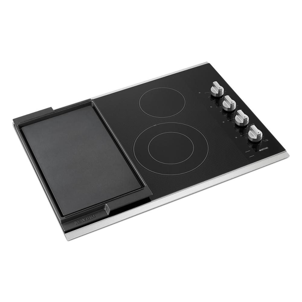 Electric cooktop with dual heating elements, reversible grill and griddle, and four control knobs for kitchenware collections