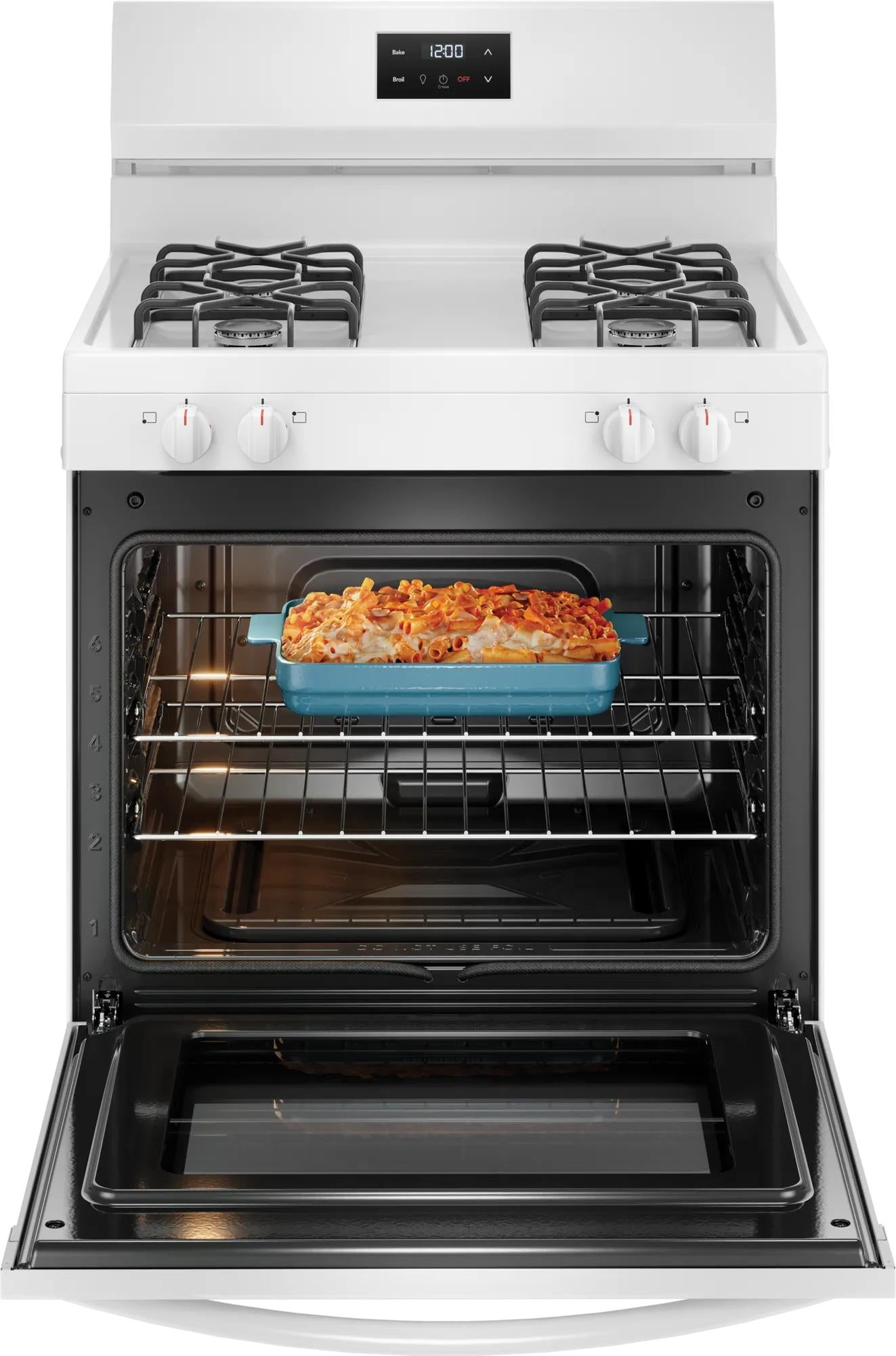white gas range with four burners and digital clock featuring a baked pasta dish inside the open oven door