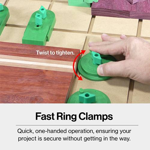 Hand tightening green ring clamp parts securing wood pieces on a workbench for home improvement projects