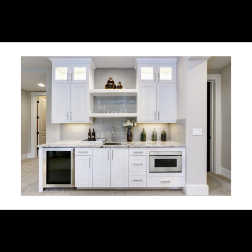 Modern kitchen wet bar with built-in microwave drawer, white cabinetry, granite countertop, and under-cabinet lighting in appliances collection