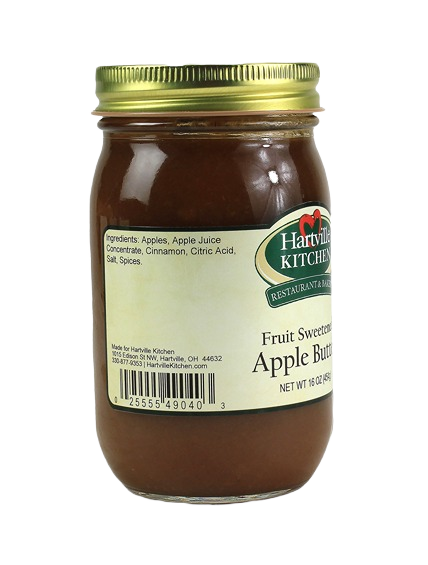 Glass jar of fruit sweetened apple butter with gold lid and Hartville Kitchen label on white background