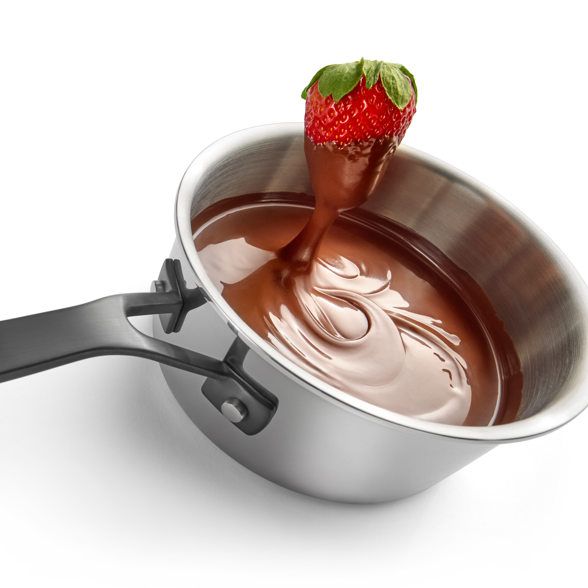 Stainless steel saucepan filled with melted chocolate and a strawberry dipped, highlighting kitchenware for home improvement tools