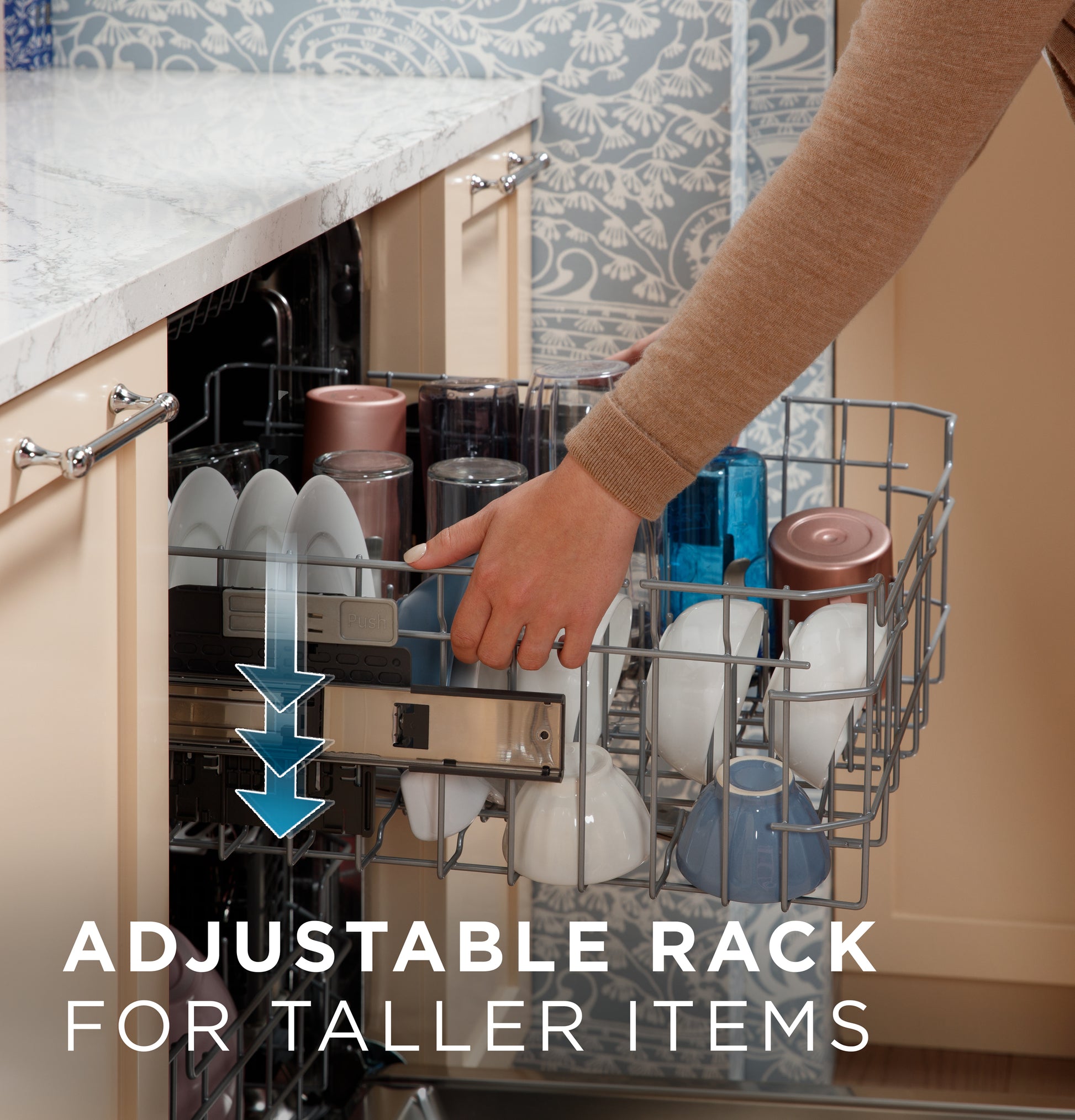 Hand adjusting upper dishwasher rack to accommodate taller dishes inside a stainless steel kitchen appliance rack