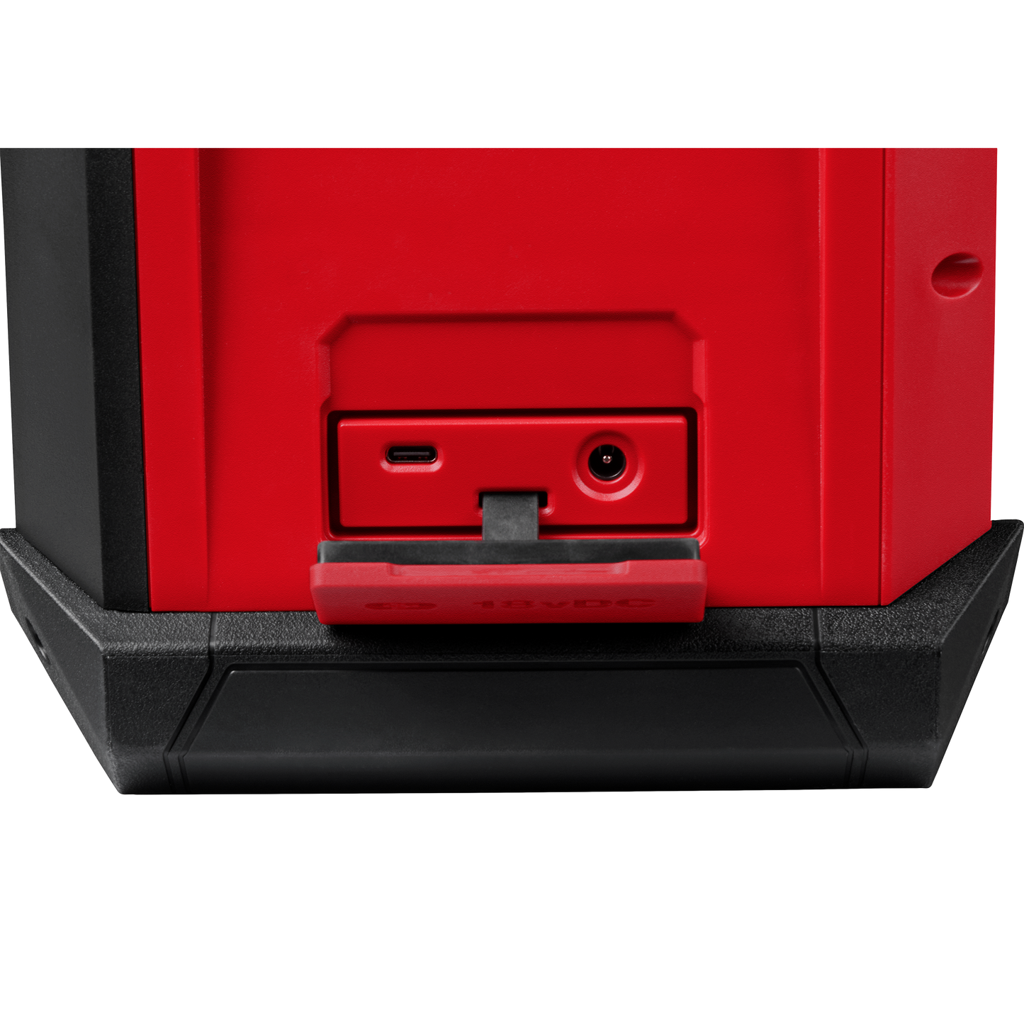 Close-up of red and black Bluetooth jobsite radio showing USB-C and power input ports with protective cover open