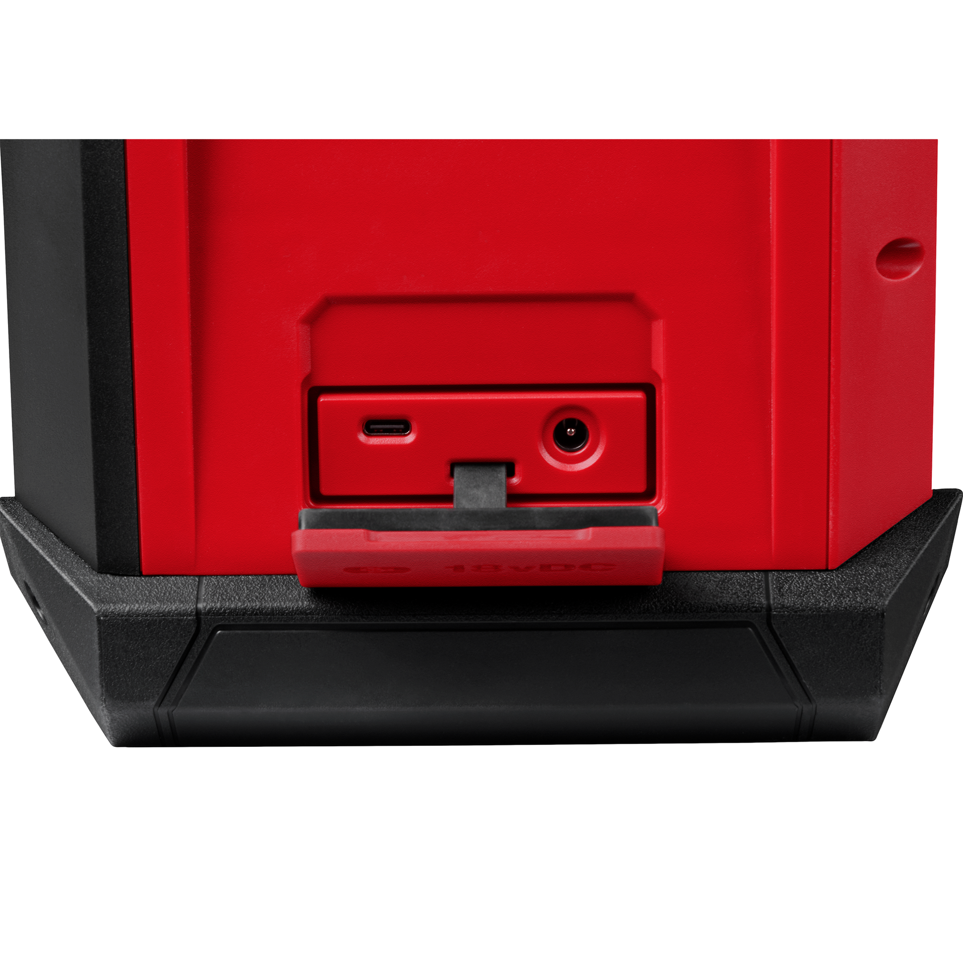 Close-up of red and black Bluetooth jobsite radio showing USB-C and power input ports with protective cover open