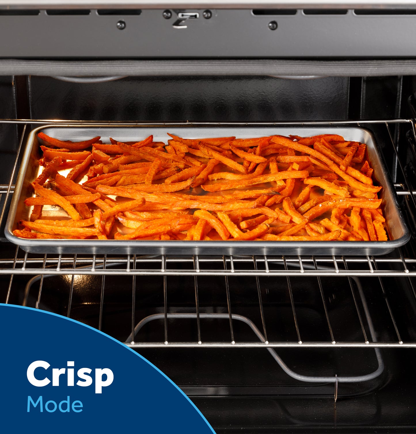 Tray of golden-brown fries cooking inside a stainless steel electric oven with Crisp Mode for home improvement.