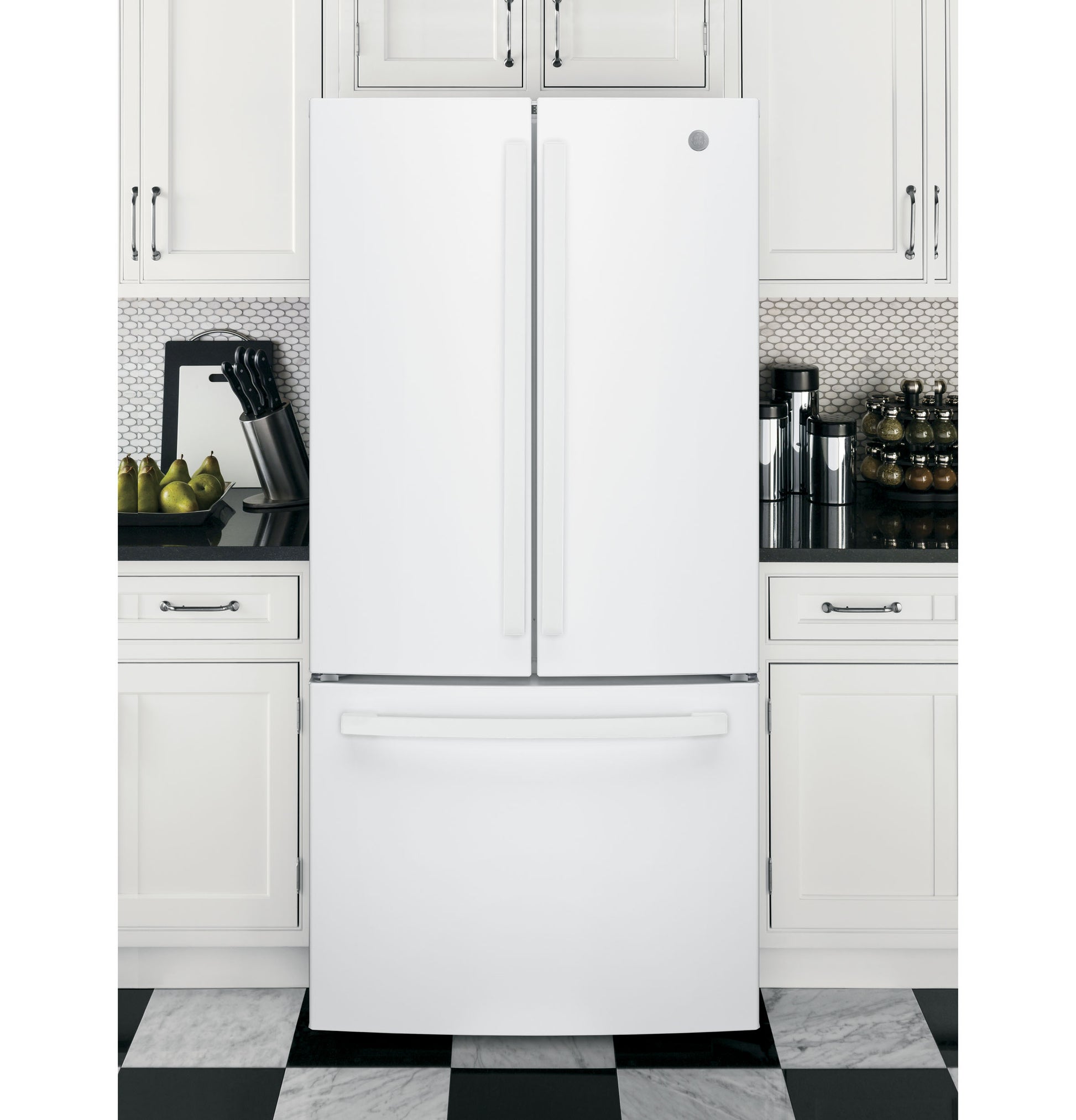 White French door refrigerator with bottom freezer integrated into modern kitchen with white cabinets and checkered floor