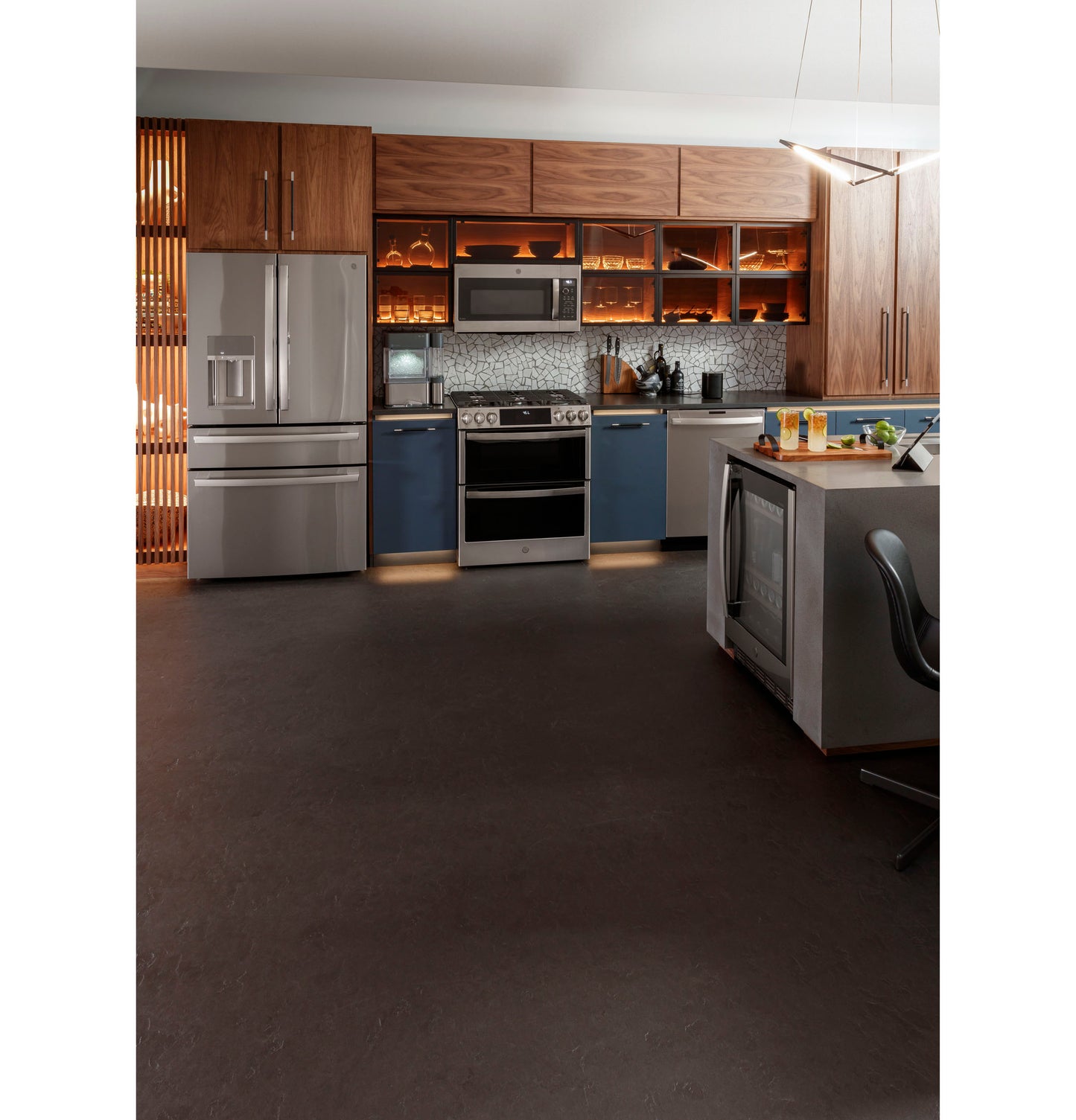 Modern kitchen featuring a stainless steel gas double oven range with blue cabinets and wood-paneled upper storage in Ranges collection