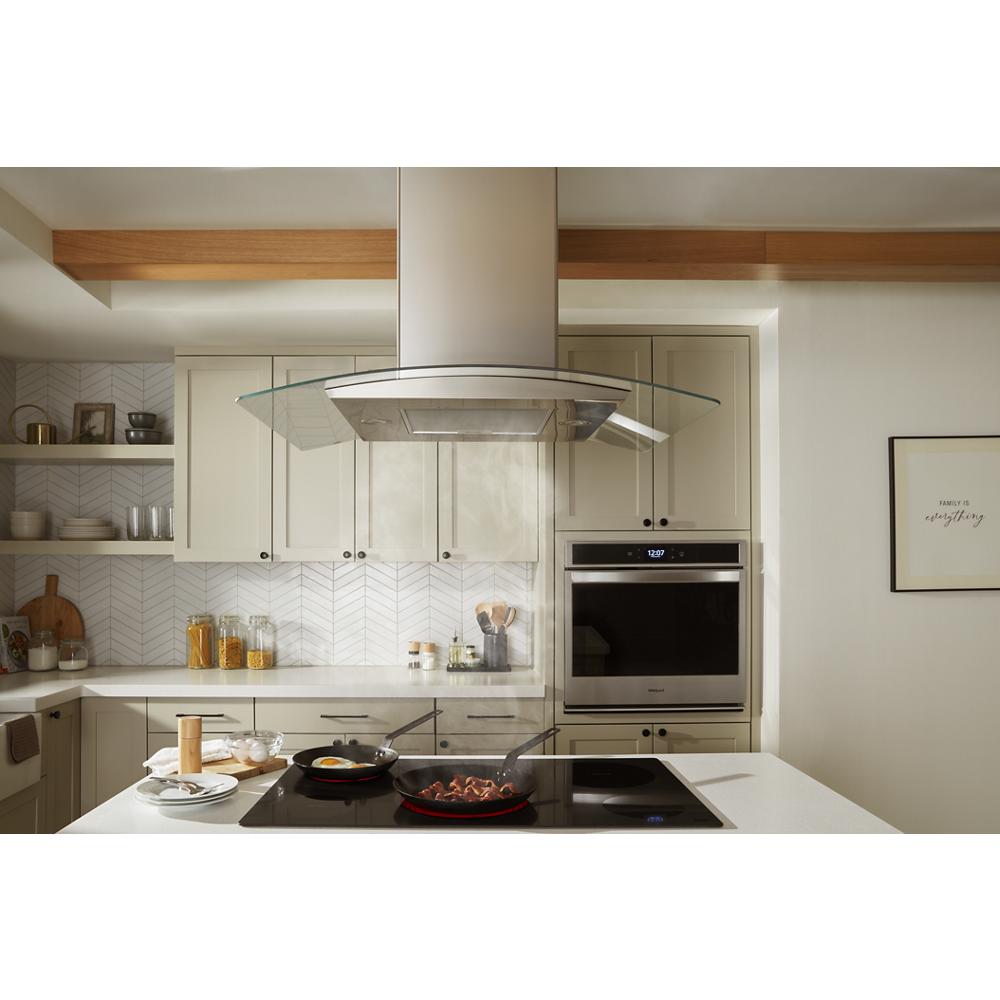 Modern kitchen featuring a 36" curved glass island vent hood over cooktop, part of Island Range Hoods collection