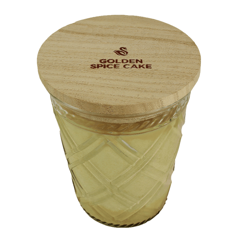 Glass candle jar with textured design and wooden lid engraved with Golden Spice Cake branding