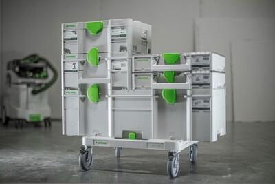 Stacked gray and green interlocking tool storage boxes on wheeled cart for workshop organization and jobsite storage solutions