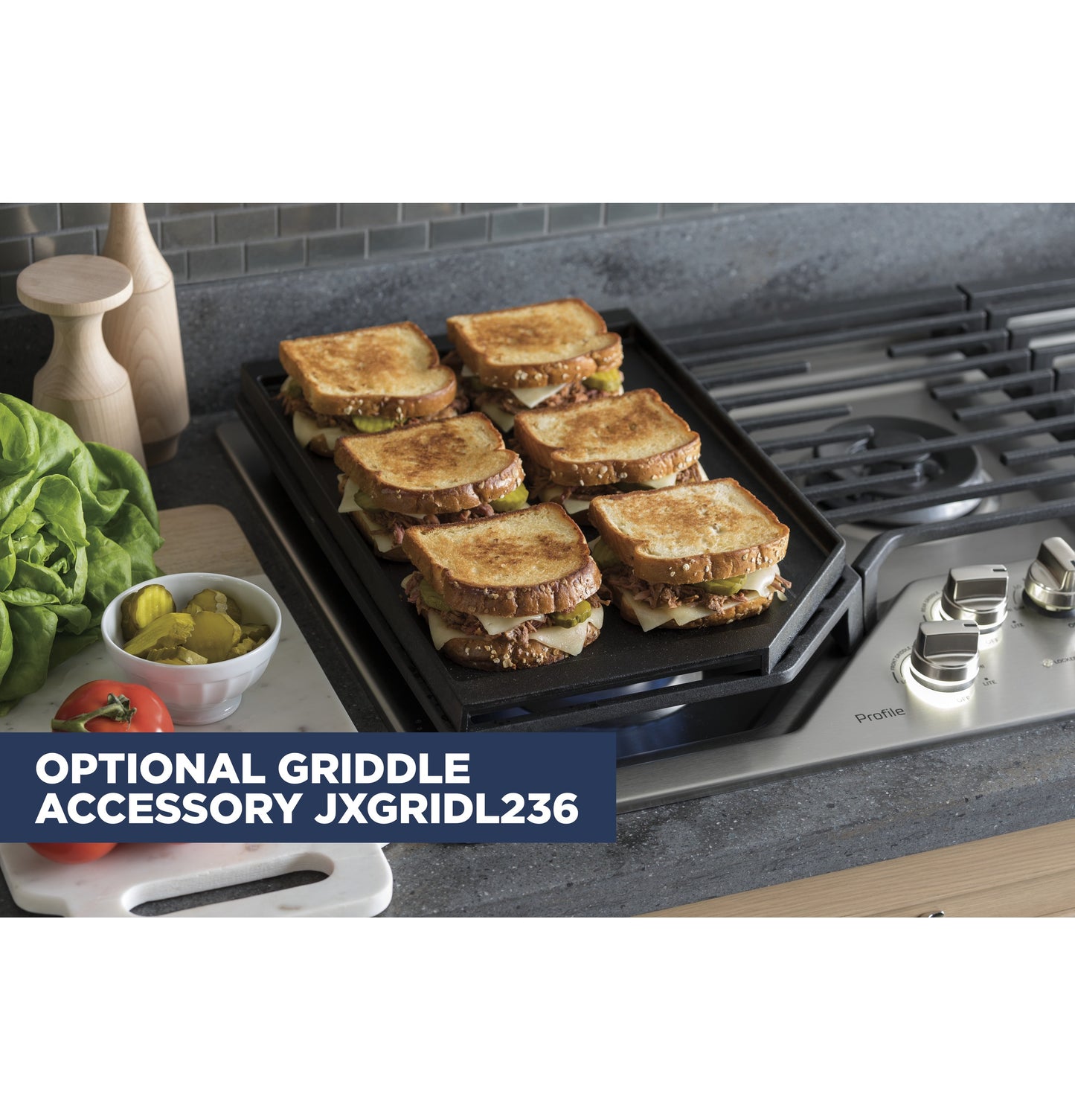 Six toasted sandwiches cooking on a griddle accessory on a stainless steel built-in gas cooktop in a kitchen setting