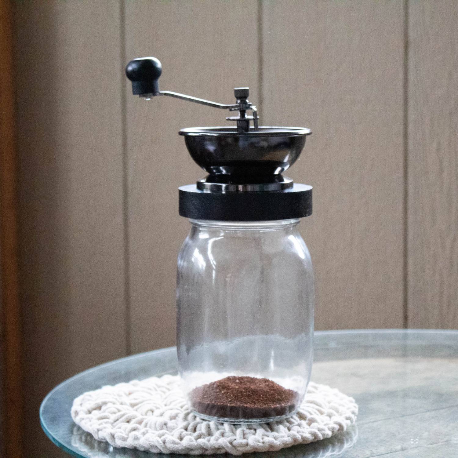 Hand crank coffee grinder with stainless steel bowl and clear glass jar, part of kitchen gadgets under $50 collection