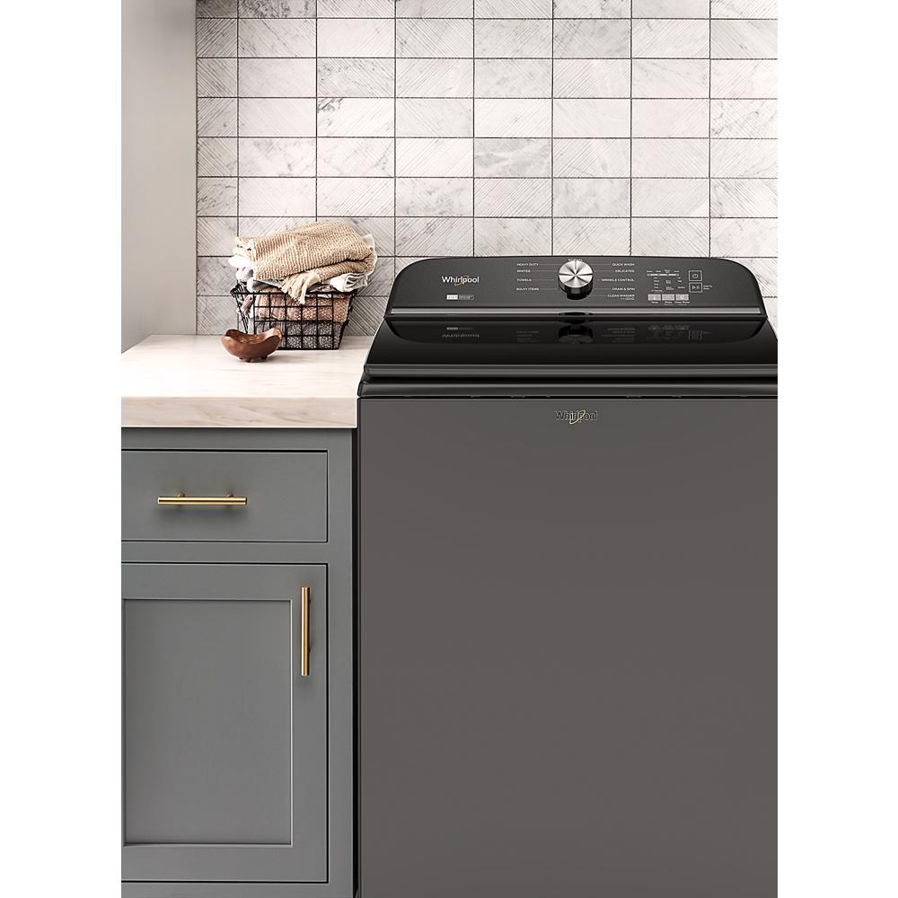 Dark gray top load washer with digital controls next to gray cabinetry in washers and appliances collection