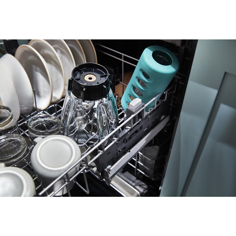 Open dishwasher loaded with plates, glassware, and a teal reusable water bottle in kitchen appliances setting