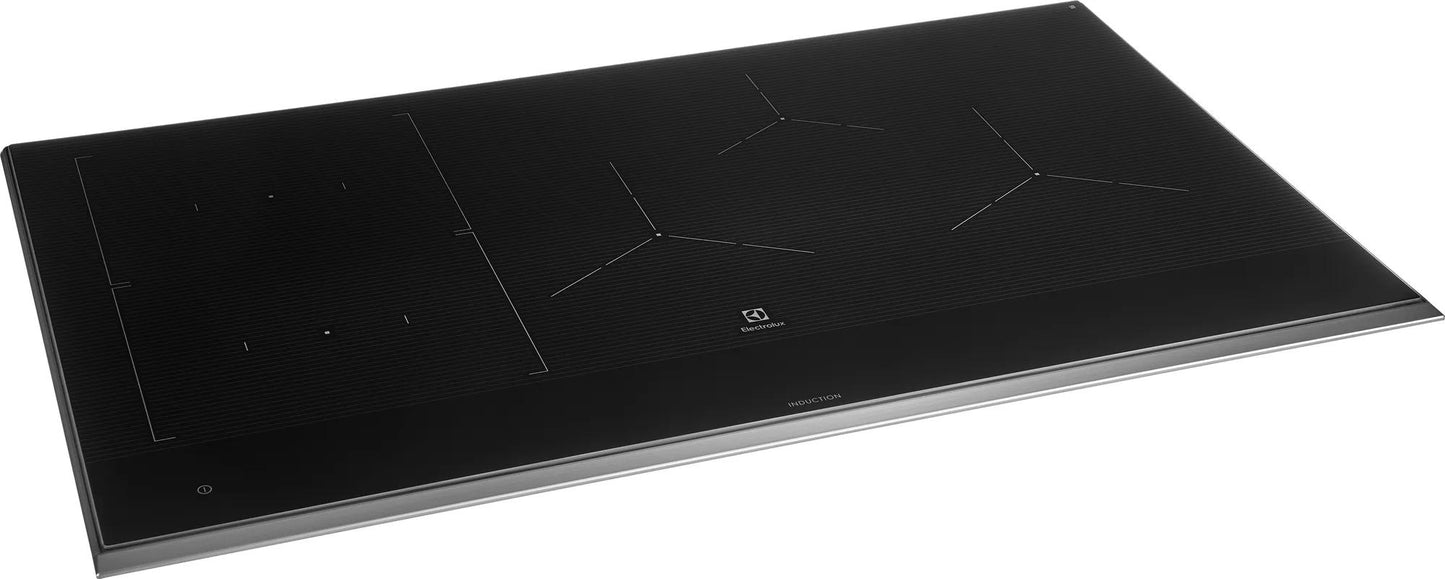 36-inch black induction cooktop with multiple heating zones and sleek glass surface in kitchen appliances collection