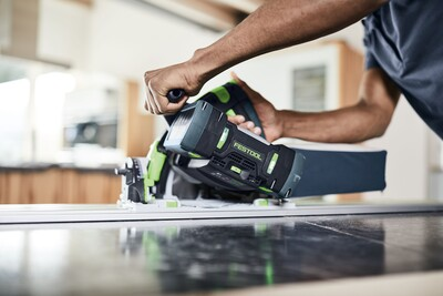 Operator using Festool track saw with dust bag attachment for clean cutting in power tool accessories collection