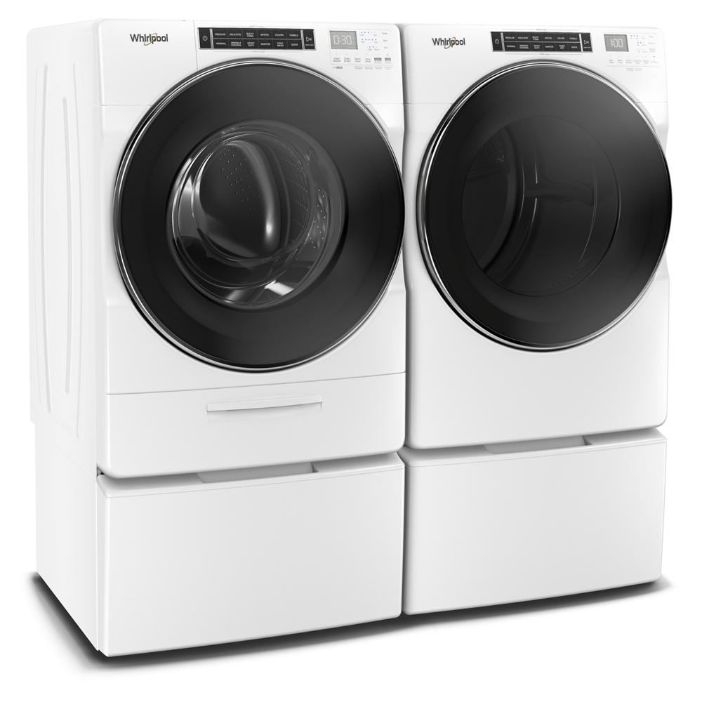 Side view of white front load washer and matching gas dryer with digital control panels in laundry appliances collection