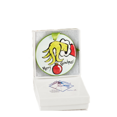 Hand-painted ceramic ornament with whimsical green hand holding red bauble and Merry Grinchmas text in box under $50